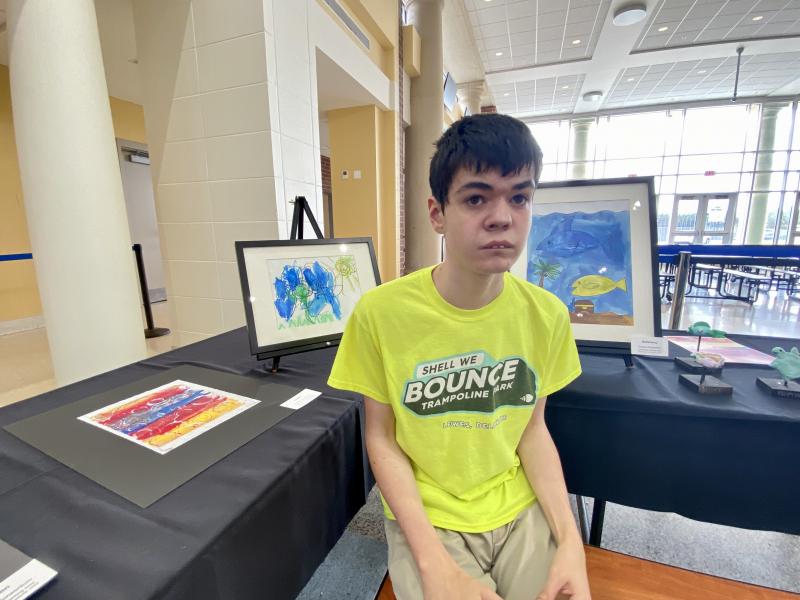 Sussex Consortium student Jeffrey Workman sits by the artwork he created in the Art Works for All after-school program. ELLEN DRISCOLL PHOTOS
